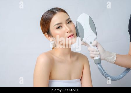 Asian Beauty Undergoing Laser IPL (Intense Pulsed Light) Treatment isolated white background Stock Photo