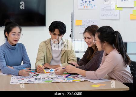 Creative UX Developer and UI Designer Team Brainstorming Session in Modern Office with Colorful Sticky Notes and Diagrams Stock Photo
