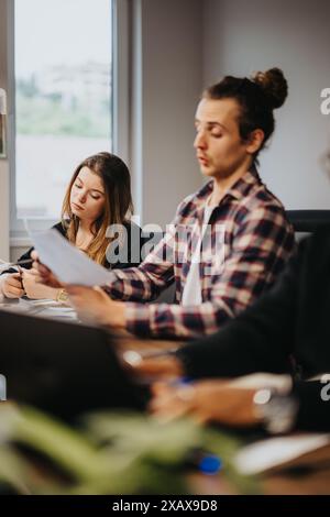 Business colleagues engaged in a project discussion at a modern office Stock Photo