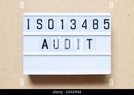 Lightbox with word ISO13486 audit on wood background Stock Photo