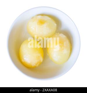 three peeled raw frozen eggs in bowl isolated on white background Stock Photo