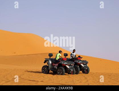 Quad bikers on the sand dunes at Taghit in Western Algeriasand dune Stock Photo