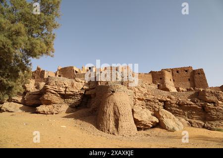 Tourists at the ancient mudbrick village at Taghit in Western Algeria Stock Photo