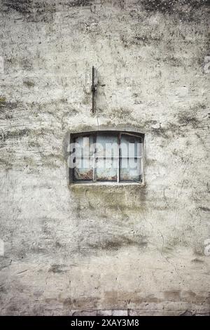 Small window in an old concrete wall. Stock Photo