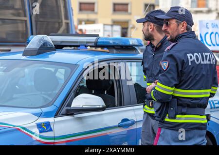 Florence, Italy - April 02 2019: Two officers of the Polizia Stradale near their car. The Polizia Stradale is the national highway patrol of Italy and Stock Photo