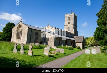 St Denys church, with tower surrounded by a graveyard and lush greenery under blue sky Stanford in the Vale. Stock Photo