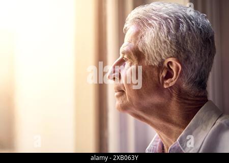 Thinking, depression and senior man in home living room to remember memory, reflection or vision. Sad, retirement and serious person with alzheimer Stock Photo