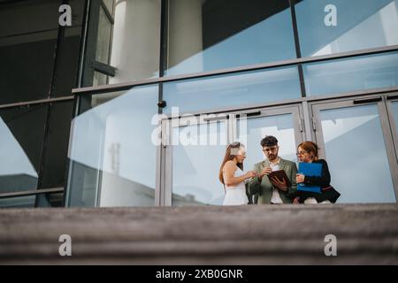 Business workers using digital tablet discussing new project in outdoor meeting at urban city area Stock Photo