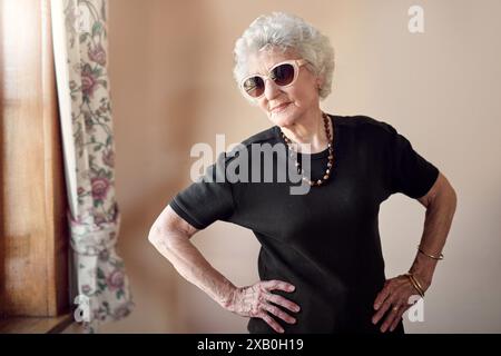 Fashion, sunglasses and senior woman with attitude in retirement home for stylish, cool and unique fun aesthetic. House, trendy and proud elderly Stock Photo