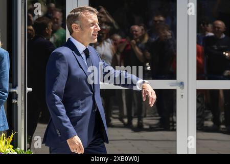 Le Touquet. 9th June, 2024. French President Emmanuel Macron walks out of a polling station after voting for the European Parliament elections in Le Touquet, France on June 9, 2024. Macron announced dissolution of the National Assembly and called new legislative elections Sunday evening after his Renaissance party suffered a heavy defeat in the European Parliament (EP) elections, according to a live broadcast of local media BFMTV. Credit: Frank Boham/Xinhua/Alamy Live News Stock Photo