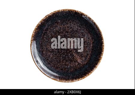 Empty black craft plate on table. Table setting. Isolated on white background. Stock Photo