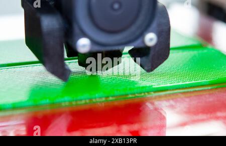 3D printer close up. Working 3D printer close-up. The process of printing on a 3D printer. 3D printer creating an object from molten plastic. Stock Photo