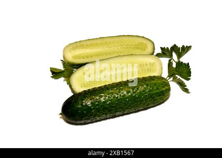Two ripe cucumbers, one whole and the other cut in half. Stock Photo