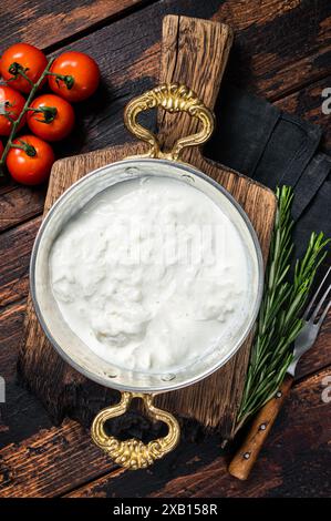 Straciatella fresh italian creamy cheese. Wooden background. Top view. Stock Photo