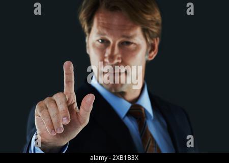 Man, suit and touch for interactive screen, button and digital for business and information online. Young person with finger on device or technology Stock Photo