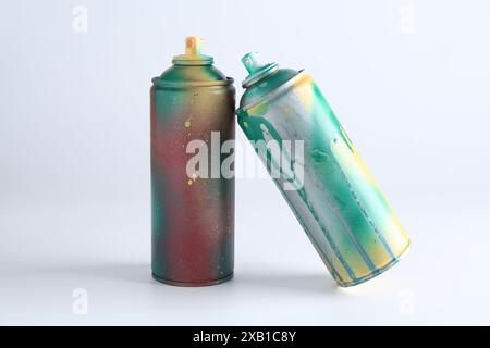 Two spray paint cans on white background Stock Photo