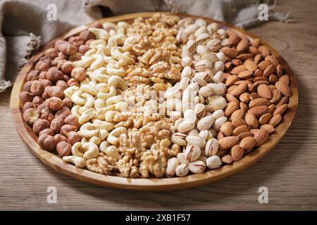 close up of plate of mixed nuts on wooden table Stock Photo
