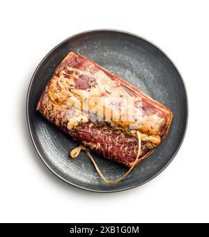 Smoked Pork meat on black plate isolated on a white background. Stock Photo