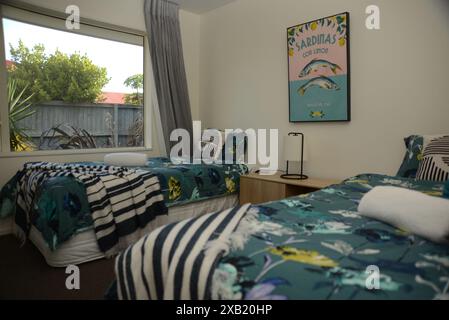 CHRISTCHURCH, NEW ZEALAND, FEBRUARY 27, 2023: Interior of a modern bedroom with two single beds, bedside cabinets and stylish interior design. Stock Photo