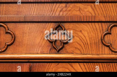 Decorative carving design elements of vintage wooden furniture panel, close up photo, front view Stock Photo