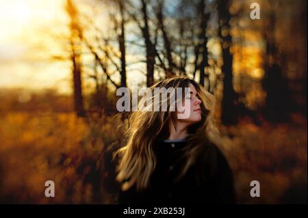 Beautiful teenager flipping long blonde hair outdoors Stock Photo