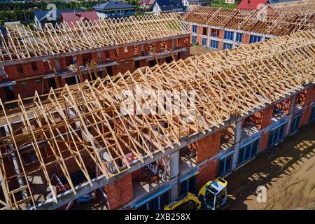 New house under construction, wooden truss system forming roof. Process of building project. Stock Photo