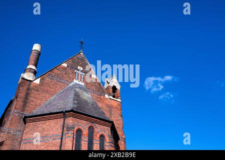 Wisp of cloud in a deep blue sky by All Souls Church, St Margarets, Twickenham, London Stock Photo