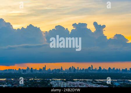 Sunrise over modern buildings in district center. Heavy cumulus before storm weather city silhouette skyscrapers sunset sky Panoramic skyline view cit Stock Photo
