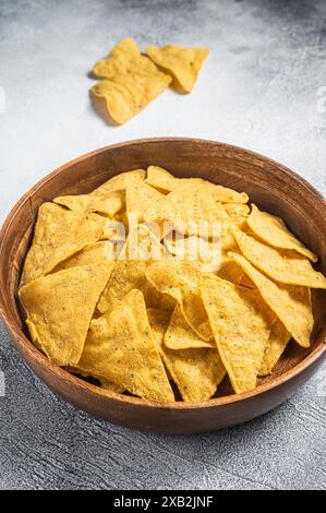 Mexican nachos corn chips in a wooden plate. White background. Top view. Stock Photo