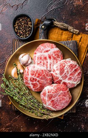 Raw french meatballs cutlet with spices and herbs. Dark background. Top view. Stock Photo