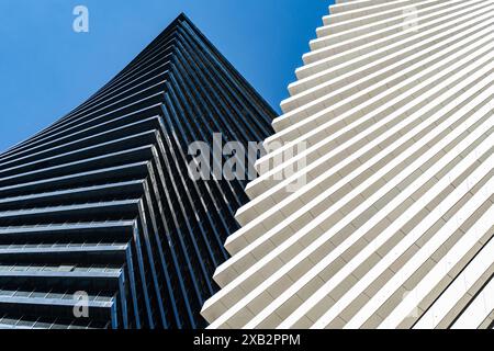 This photo captures the striking contrast between modern spiral architectural styles in Tbilisi, featuring sleek black panels against pristine white f Stock Photo