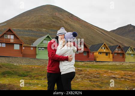 Young tourists in Longyearbyen, Svalbard. Summer time adventure travel in Norwegian Arctic. Stock Photo