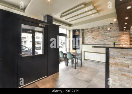 Contemporary kitchen design featuring stone brick wall, sleek surfaces, and stylish lighting at Blassiusstraat 5-1 Stock Photo