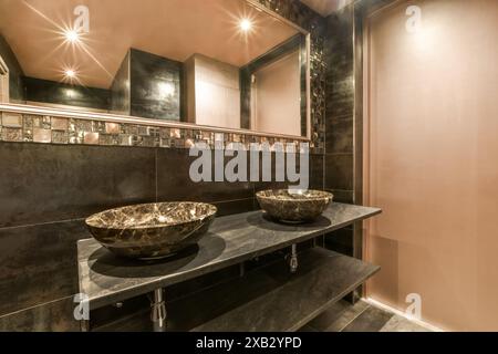 Elegant bathroom featuring double marble vessel sinks, mirrored wall, and warm lighting at Blassiusstraat 5-1 Stock Photo