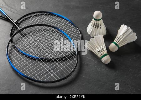 Feather badminton shuttlecocks and rackets on grey textured table Stock Photo