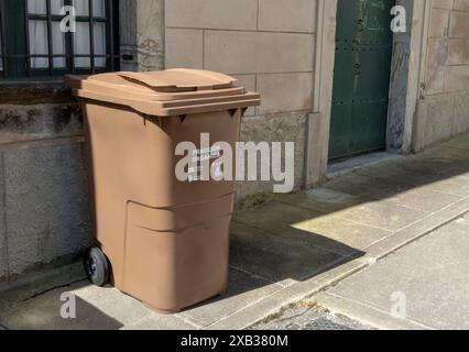 CASTROPOL, SPAIN - JUNE 02, 2024:Brown organic waste bin in Castropol,Asturias,Spain.Intelligent waste collection managed by COGERSA company. Stock Photo