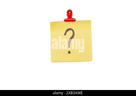 Question mark on a yellow sticky paper hanging from a red clip on a white background Stock Photo