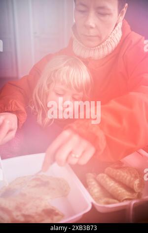 Mother and daughter having breakfast together at home Stock Photo
