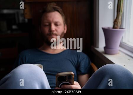 Man using smart phone while sitting at home Stock Photo