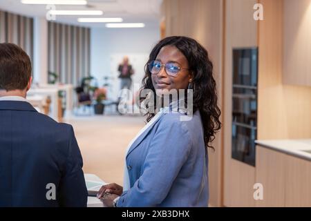 Portrait of confident businesswoman in office cafeteria Stock Photo