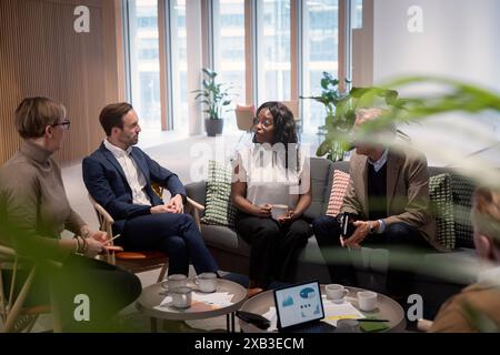 Multiracial business colleagues discussing in meeting at corporate office Stock Photo