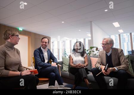 Businesswoman discussing with colleagues in meeting at corporate office Stock Photo