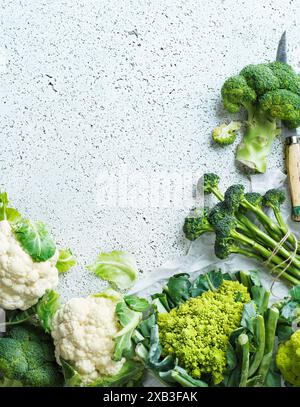 Broccoli and various cauliflowers kept on white table Stock Photo