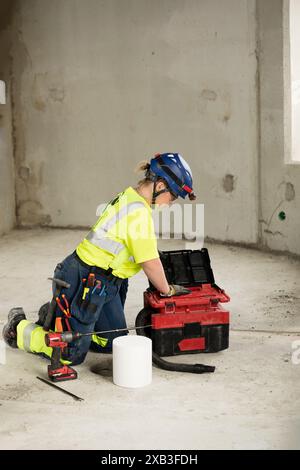 Full length of female engineer with equipment working at construction site Stock Photo