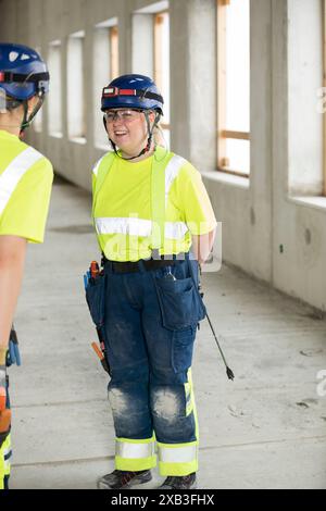 Smiling female engineers discussing while standing at construction site Stock Photo