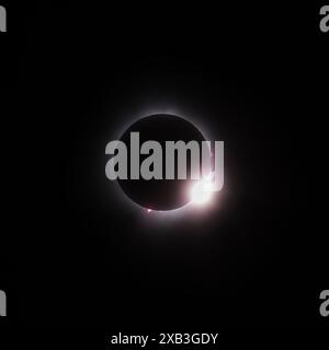 The total solar eclipse just as the sun begins to appear looks like a diamond ring. Stock Photo
