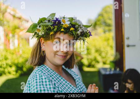 Portrait of smiling young woman wearing tiara in back yard Stock Photo