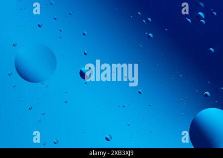 Abstract visual with blue and purple bubbles on a dark blue background, creating a serene and tranquil artistic pattern Stock Photo