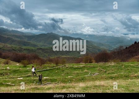 People Walking on Hiking Trail in Mountains Stock Photo