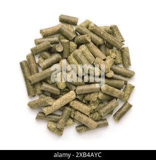 Top view of dry  green grass pellets isolated on white Stock Photo